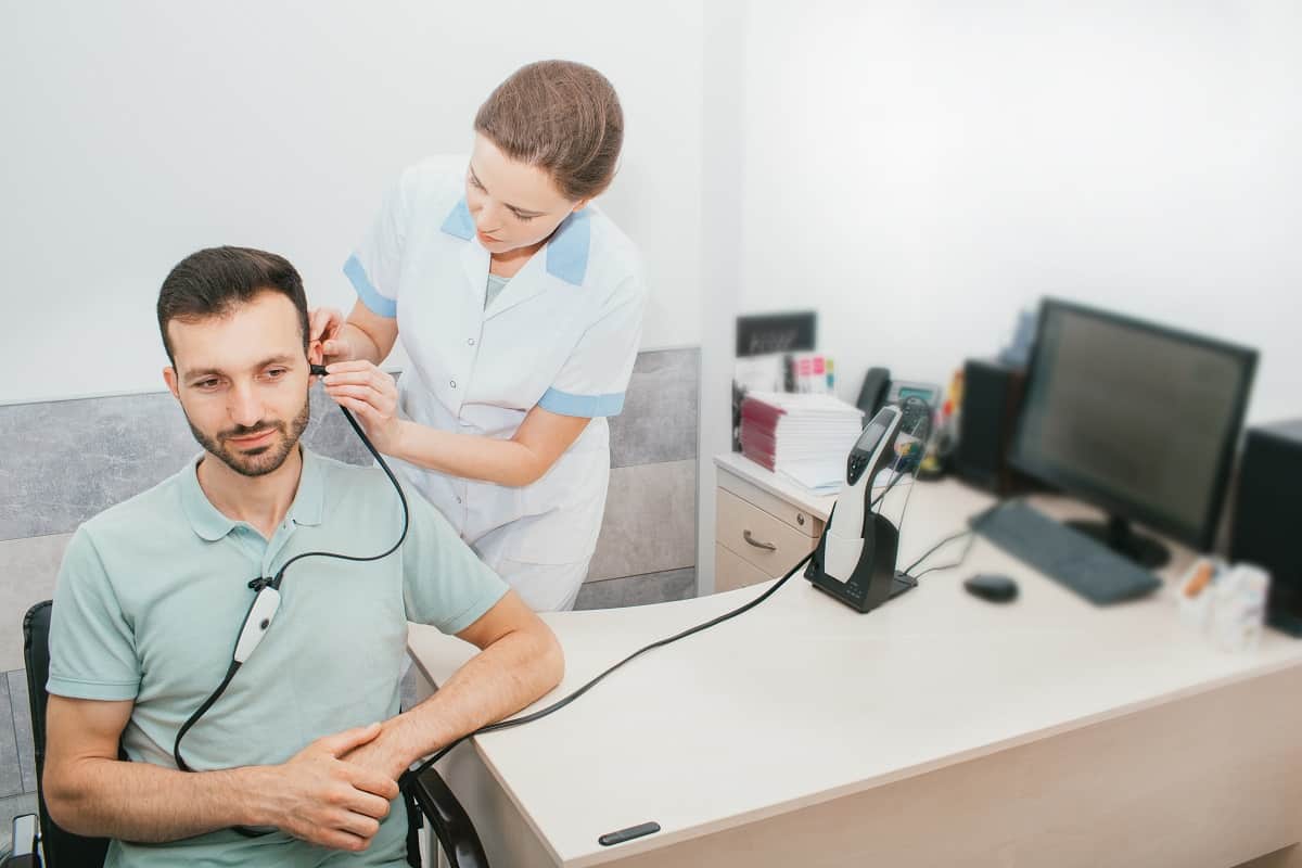 Mixed Race Man Having A Hearing Test With Special Medical Equipm